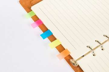 close up of empty notebook (memo) open with colour tabs for bookmarks