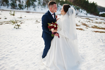 Amazing young wedding couple in love at winter day