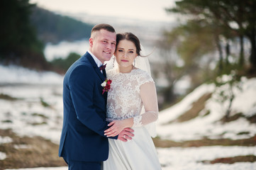 Amazing young wedding couple in love at winter day