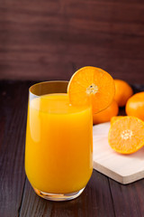 Orange juice on wooden background