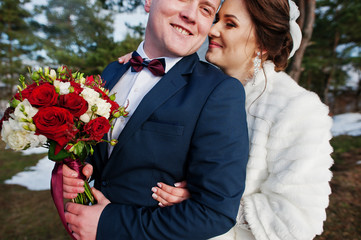 Amazing young wedding couple in love at winter day