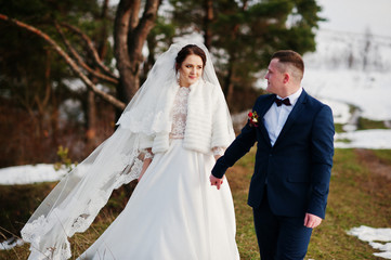 Amazing young wedding couple in love at winter day