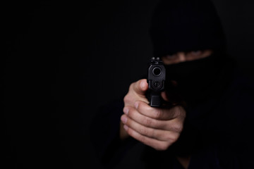 Man's hands aiming with gun.