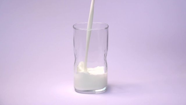 Milk pouring into glass shooting with high speed camera, phantom flex.