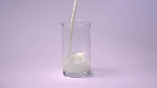 Milk pouring into glass shooting with high speed camera, phantom flex.