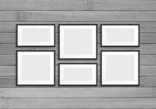 Collage of black wooden frames on old wood panels wall. Retro style mock up