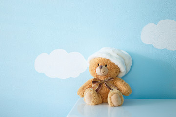 Sitting toy bear on the background of Wallpapers of clouds and sky