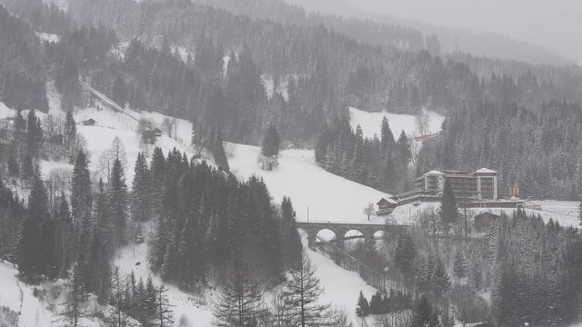 Typical winter landscape in the Austrian Alps with snowfall and blizzard