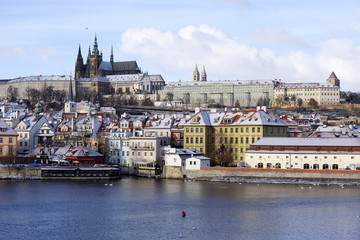 Snowy freeze Prague Lesser Town with gothic Castle above River Vltava, Czech republic