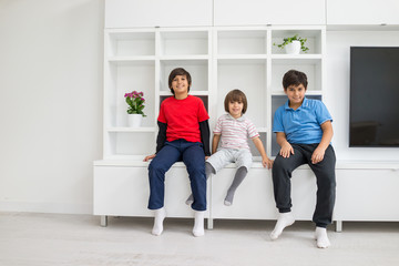 Obraz premium Happy children having fun and posing in new modern home