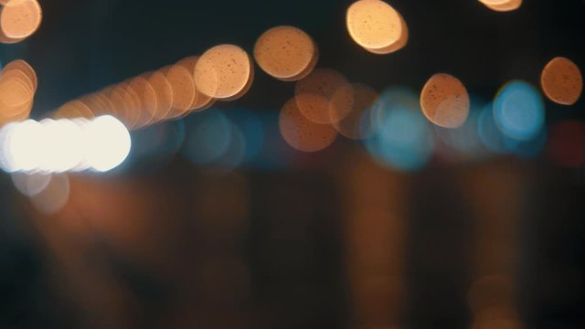 Defocused lights of cars in the night