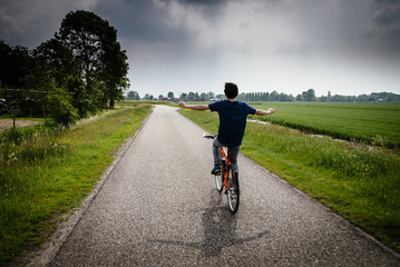 Young boy is riding bicycle in the Netherlands