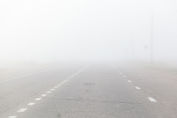 mist over asphalt road at dawn