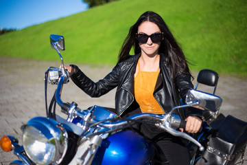 Fototapeta na wymiar portrait of beautiful woman sitting on retro motorcycle
