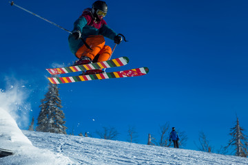 Skier on off-piste slope in forest riding very fast. Ski backcountry resort Sheregesh.
