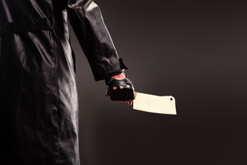 Killer holding meat cleaver in hand.