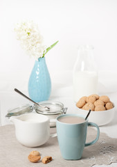 Hyacinth Flowers In Vase. Amaretti Biscuits. Cup Of Tea