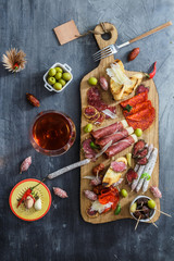 Different spanish embutidos on a table: jamon, chorizo, salami, cheese and wine. Top view