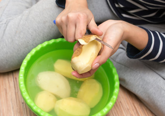 woman peeling potatoes