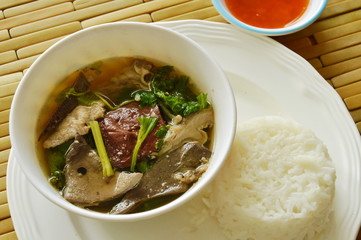boiled pork blood and entrails soup eat couple with rice on dish

