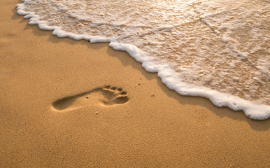 Bubbles waves and foot print on the beach  background..
