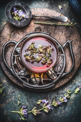 Fototapeta na wymiar Healthy herbal tea concept , cup of tea with fresh herbs and flowers on rustic vintage background, top view