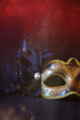 Image of black elegant venetian mask on glitter background. Shiny overlay © tomertu