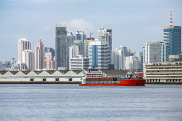 ship cargo containers passing through many towns