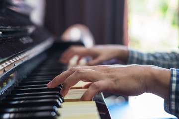 Hands musician playing the piano closeup