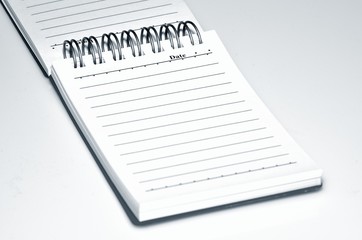 Open notebook on a white background close-up.