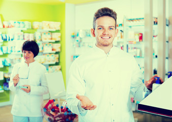Portrait of two friendly glad pharmacists