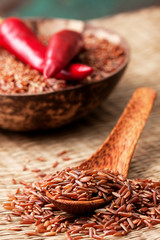 red rice in a wooden spoon