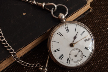 Silver pocket watch and Bible