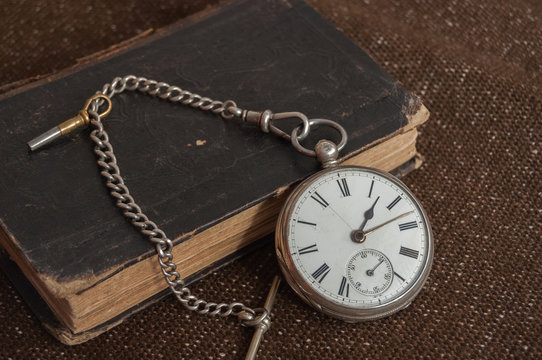 Silver pocket watch and Bible