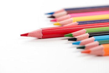 Fototapeta premium Colored pencils arranged on the table in natural light