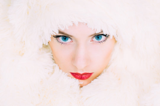 Portrait of young beautiful girl in retro style in fur, stand at gaze