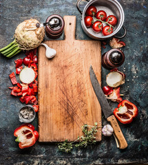 Wooden cutting board with organic vegetables and kitchen knife,  healthy food background, top view,...