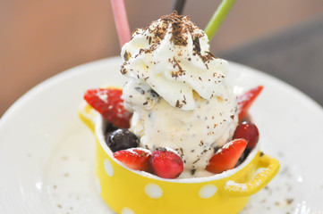 ice cream with whipped cream and berry dish