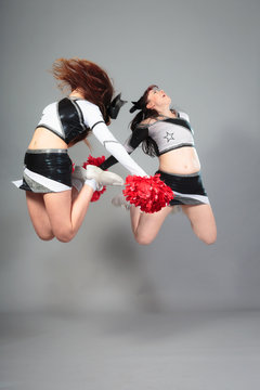 Two Cheerleaders Jumping