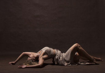 Fototapeta na wymiar Young beautiful dancer in beige dress