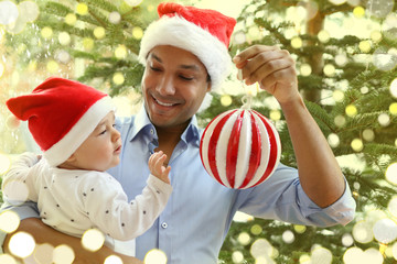 Father and baby decorating the christmas tree