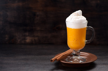 Spice pumpkin latte smoothies on rustic background