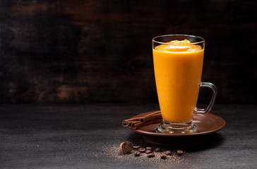 Spice pumpkin smoothie on a rustic background