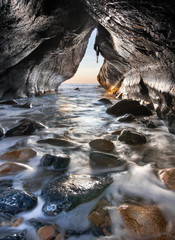 Follow the light inside a isolated and natural sea cave - 132518013