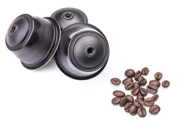 Coffee capsules and coffee beans isolated on white background