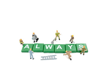 Naklejka premium Miniature worker team building word always on white background