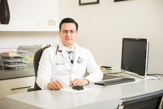 Hispanic young doctor in his office