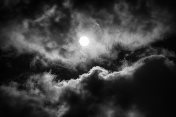 The moon on the dark sky among the clouds, natural abstract background