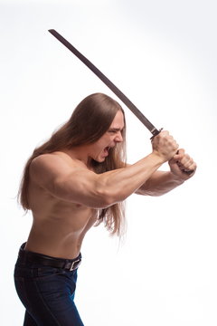 Portrait of a brutal man bodybuilder with bare-chested with long hair with a Japanese sword on a white background