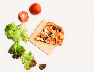 Italian pizza with mushrooms, ham and vegetables on a plate on a white background.